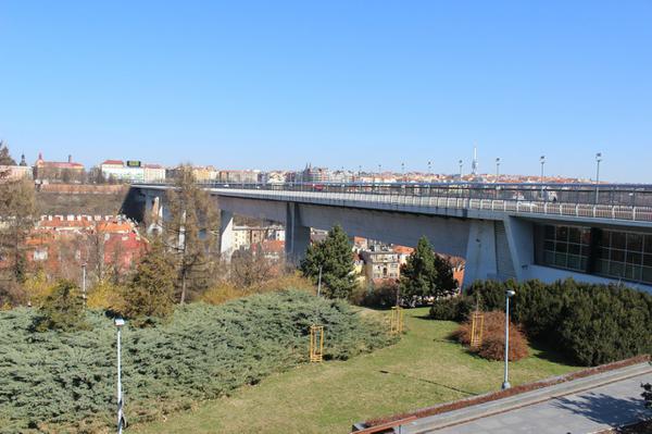 The thick concrete support under the bridge contains the metro line.